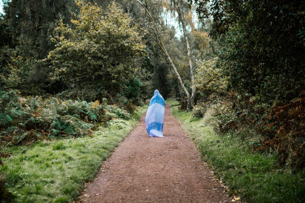 woman-walking-path-with-head-covered